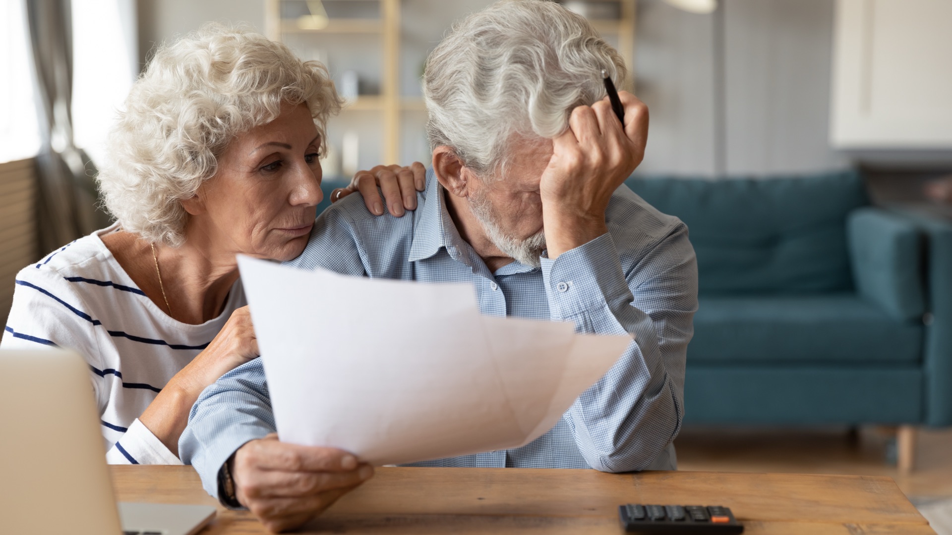 Senior couple reviewing care plans with a professional