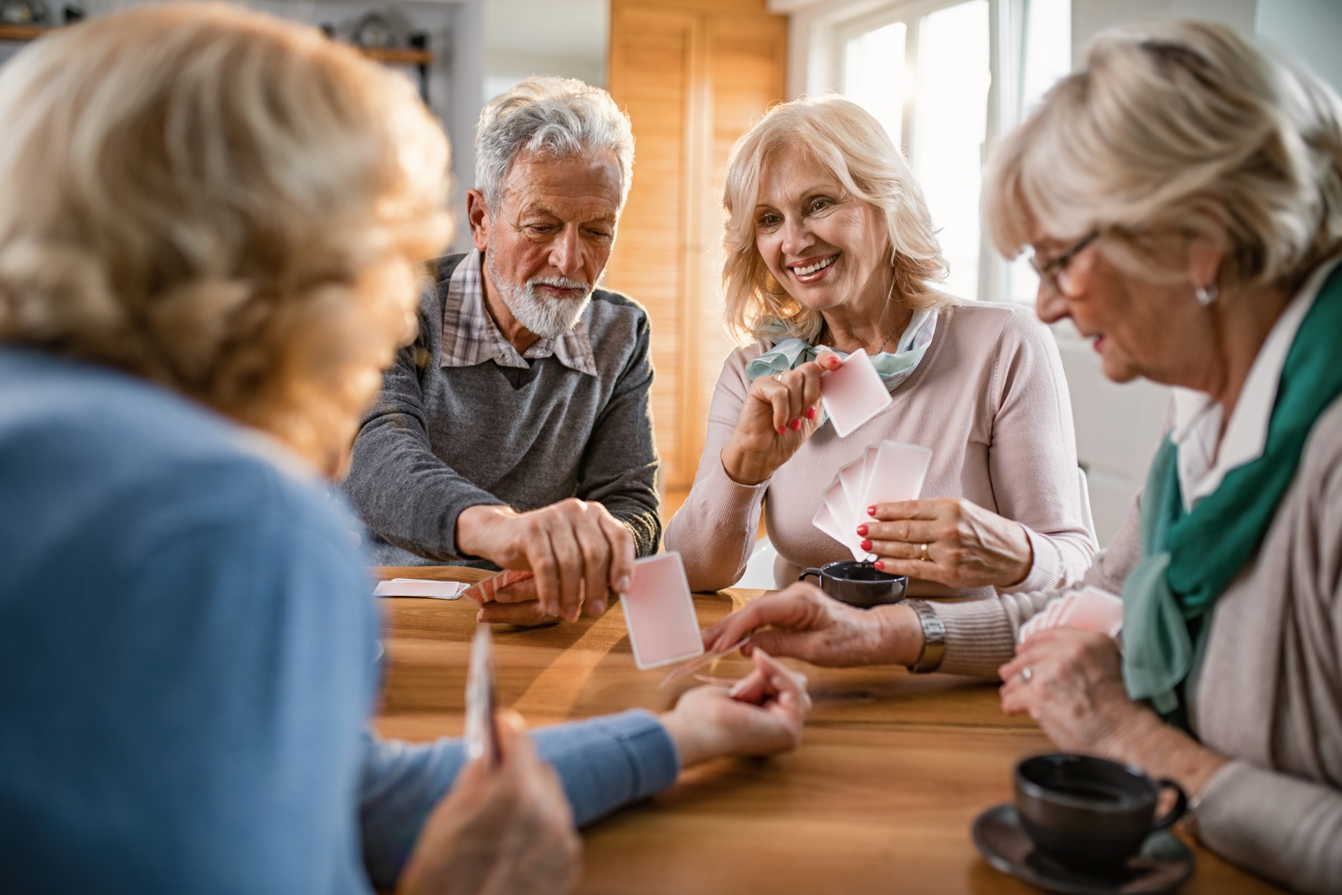 Seniors enjoying social activities and playing cards together